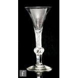 An 18th Century drinking glass circa 1750, the trumpet bowl above a medial knop, single series