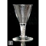 A late 18th Century colour twist drinking glass circa 1765, the conical bowl above a double series