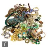 A parcel lot of assorted costume jewellery to include beads, brooches, earrings, pendants,