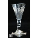 An 18th Century ale glass circa 1780, the conical bowl engraved with stylised flowers and foliage