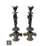 A pair of late 19th Century painted cast iron candlesticks, the columns modeled in the form of a