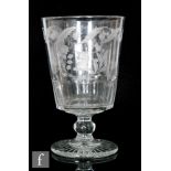 An early 19th Century oversized glass rummer, the bucket bowl with slice cut base, engraved with a