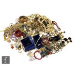 A large parcel lot of assorted costume jewellery to include beads, brooches, chains, earrings,