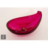 A post war Italian Murano glass dish of teardrop shape with a scrolled rim and internal applied