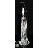 A later 20th Century French clear crystal glass lamp base by Daum, of heavy form wrythen form,