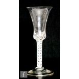 An 18th Century drinking glass circa 1770, the bell bowl with solid teared base above double