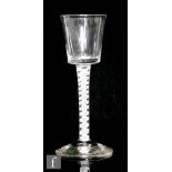 An 18th Century drinking glass circa 1760, the bucket bowl above a double series opaque twist stem
