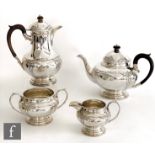 A hallmarked silver four piece tea set, circular stepped bases below bulbous bodies with part