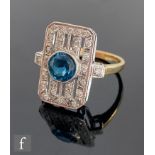 An 18ct Art Deco style blue topaz and diamond cluster ring, central topaz collar set within a canted