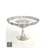 A hallmarked silver pedestal comport, circular base below knopped column and plain bowl with pierced