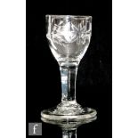 An 18th Century drinking glass circa 1770, the ogee bowl engraved with a bird and floral motif above