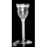 An 18th Century drinking glass circa 1765, the tall ogee bowl engraved with an upper floral border