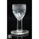 An 18th Century dram glass circa 1750, the ovoid bowl engraved with a fruiting vine over moulded