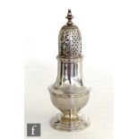 A George II hallmarked silver caster of typical baluster form terminating in knopped finial,