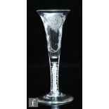 An 18th Century Jacobite wine glass circa 1750, the drawn trumpet bowl engraved with a six