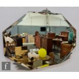 A 1930s wall mirror of canted diamond form highlighted with chrome plated fan supports to top and