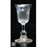 An 18th Century wine glass circa 1780, the round funnel bowl with basal moulded fluting above a true