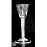 An 18th Century drinking glass circa 1750, the round funnel bowl above a single series air twist