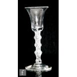An 18th Century drinking glass circa 1750, the bell bowl above a quadruple knopped, single series