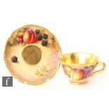 A later 20th Century Royal Worcester Fallen Fruits teacup and saucer, the teacup decorated by