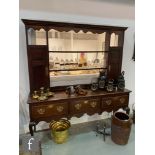 A George III and later oak dresser inlaid with a chequer strung plank top over three drawers,