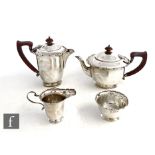 A hallmarked silver four piece tea set of plain form terminating in shaped border, total weight