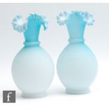 A pair of late 19th Century satin glass vases of footed ovoid form with collar neck and frilled