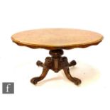 A Victorian figured walnut tilt top oval breakfast table on turned melon form pedestal and four