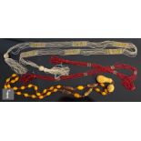 Three 1920s Flapper girl necklets to include clear and red bead example each with tassel ends and