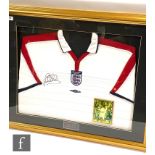 A framed England home shirt 2003/4 signed by Michael Owen, with insert action photograph, 72cm x