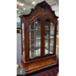 An 18th Century style Dutch figured walnut display cabinet enclosed by a pair of bar glazed doors