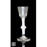 An 18th Century drinking glass circa 1765, the round funnel bowl above an opaque twist stem with