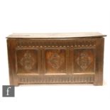 An early 18th Century carved oak coffer, the twin plank top over a lunette frieze and triple diamond
