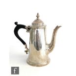 A hallmarked silver small coffee pot in the Queen Anne style terminating in ebonised scroll