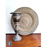 A large Indian brass plaque or table top of circular form with repousse detail, decorated with