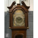An Edwardian mahogany longcase clock, the Arabic arch dial with matted centre, spandrels and eight