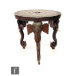 A 20th Century ebonised jardiniere stand on slender elephant style legs, diameter 36cm, and a