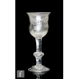 An 18th Century drinking glass circa 1740, the ovoid bowl with everted rim engraved with