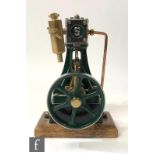 A Stuart single cylinder vertical live steam engine, painted green, with a six spoked flywheel,