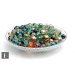 A collection of glass marbles, mostly large size, of varying swirl design and differing colours,