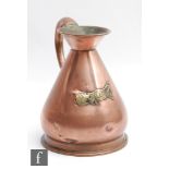 A 19th Century copper half gallon measure with an applied brass mounted plate in the form of a