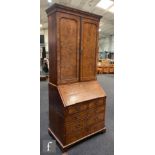 An early 18th Century crossbanded and feather banded walnut bureau bookcase, the shelf and drawer