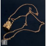 A 14ct pendant modelled as a Mosque, weight approximately 7g, suspended from a 9ct belcher link