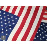 Two United States 'Stars and Stripes' woven and sewn flags, each with fifty individual stars,