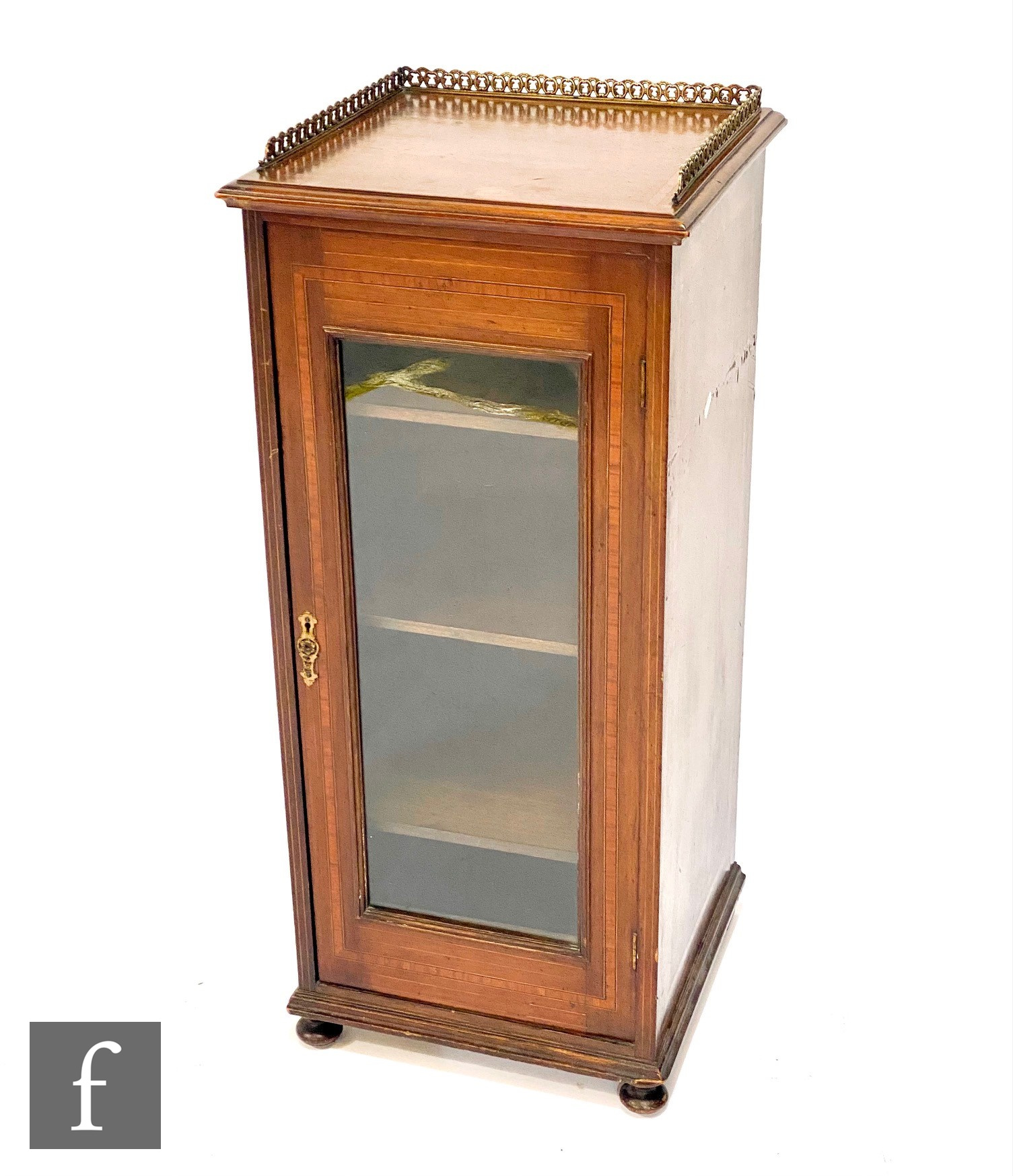 An Edwardian cross-banded mahogany pier cabinet, with a gilt metal gallery above a single glazed