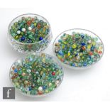 A large collection of glass marbles, to include mainly swirl examples, lots with flaws, bubbles