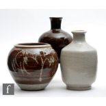 Three pieces of 20th Century studio pottery comprising a bottle vase with combed detail to the