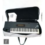 A Korg M1 Music station synthesizer, serial number 084274, sold with bag, leads and instruction