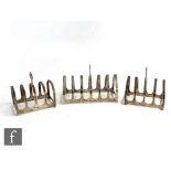 A hallmarked silver six division toast rack of plain form, with two further four division silver