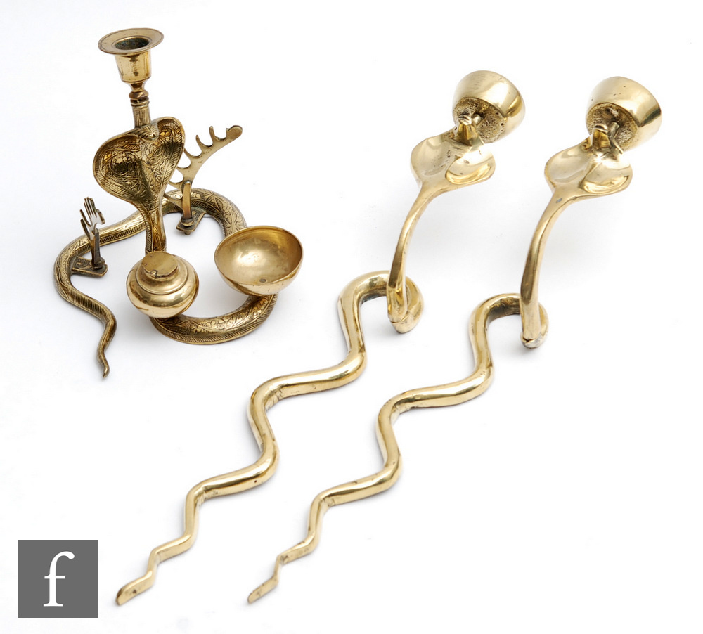 A pair of brass wall sconce candle holders modelled as stylised cobras, length 46cm, together with